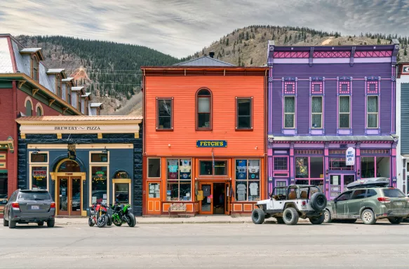 Silverton town with colourful shop buildings and rocky mountains in the background, Colorado, USA.