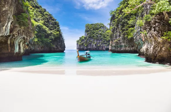 Thai traditional wooden longtail boat and beautiful beach in Phuket province, Thailand