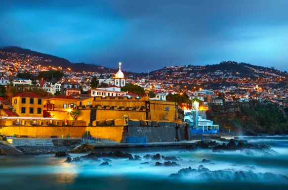 Night cityscape of Funchal and castle Fortaleza de Sao Tiago in Madeira, Portugal