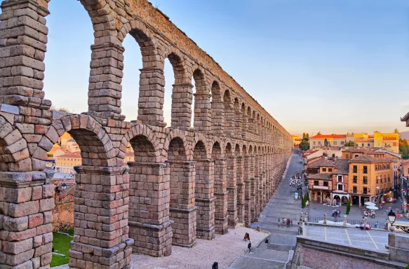 Roman aqueduct of Segovia under a sunset sky