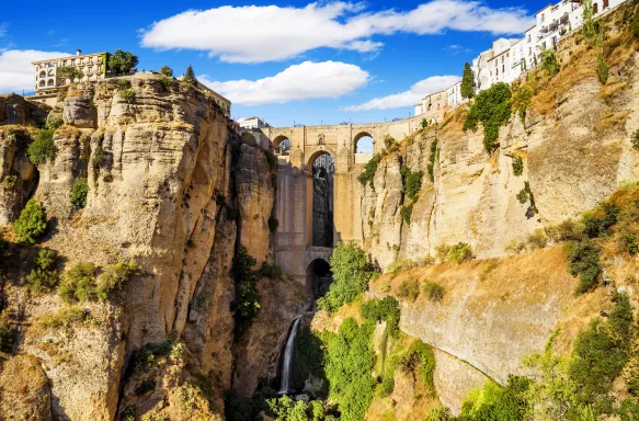 Panoramic view of Puente Nuevo, a bridge in Ronda and the famous white villages in the province of Malaga, Spain.