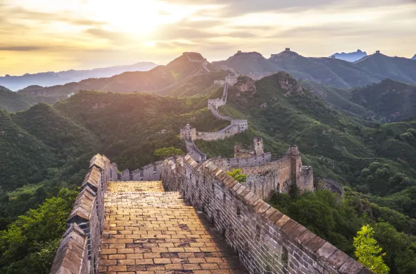 Sunrise over a view of the walkways of the great wall of China 