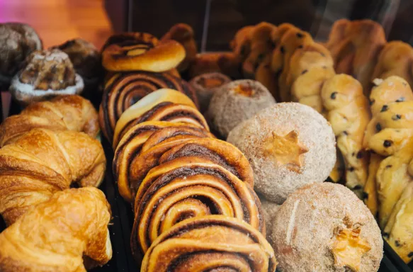 A variety of cakes and pastries on a market stall.