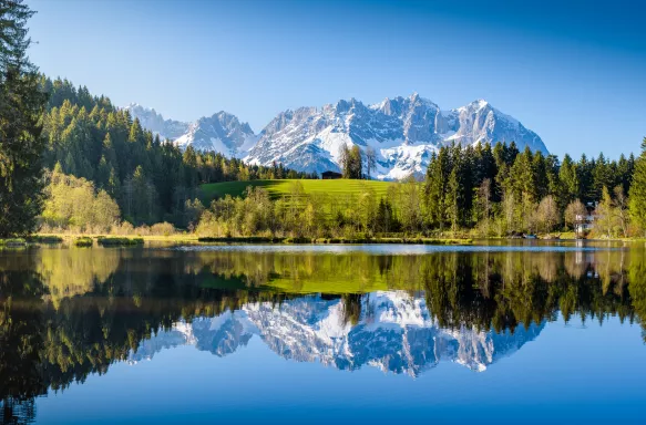 Idyllic alpine scenery with a lake and snowy mountains in Tyrol, Austria