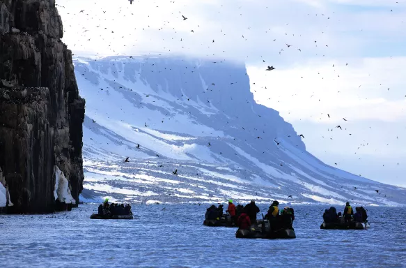 Groups of people on boats during an Arctic expedition