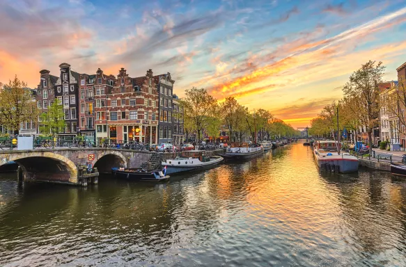 Sunset city skyline at canal waterfront in Amsterdam, Netherlands