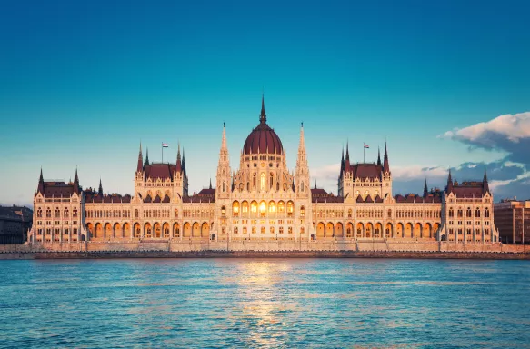 Parliament building with sun setting in windows in Budapest, Hungary