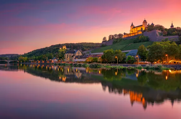 Wurzburg with Marienberg Fortress and reflection of the city in Main Rive during beautiful sunset in Wurzburg, Germany.