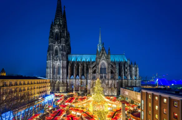 Christmas market and Catholic cathedral at night in the city of Cologne, Germany