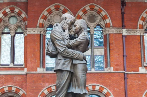 The Meeting Place bronze statue of lovers embracing each other at St. Pancras Station, London