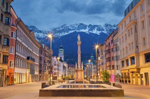 Innsbruck, Austria, during twilight with European Alps in the background.