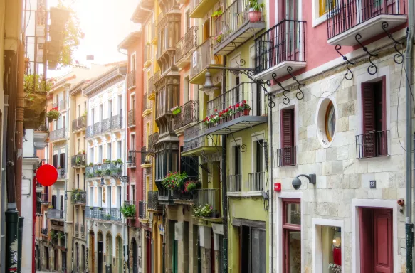 Rows of buildings in narrow ancient street in Pamplona city, Spain