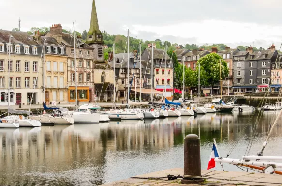 The Honfleur Harbour with docked white boats lined in a row, France