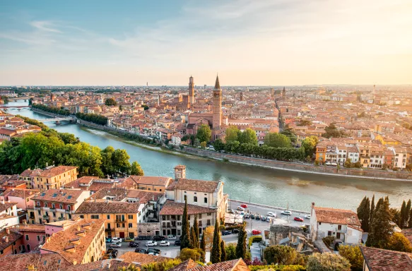 A central shot of the Adige river surrounded by european roofs of Verona