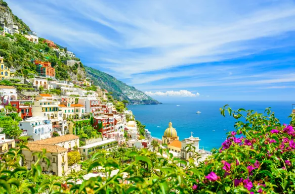 Positano on Amalfi coast with blurred flowers on foreground in Campania, Italy