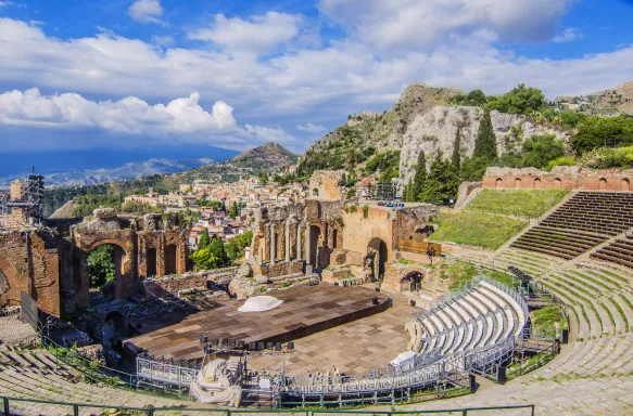 View of the Taormina theatre with Mount Etna in the distance in Italy