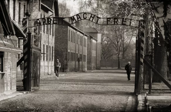 Black and white image of Auschwitz concentration camp gate, Poland