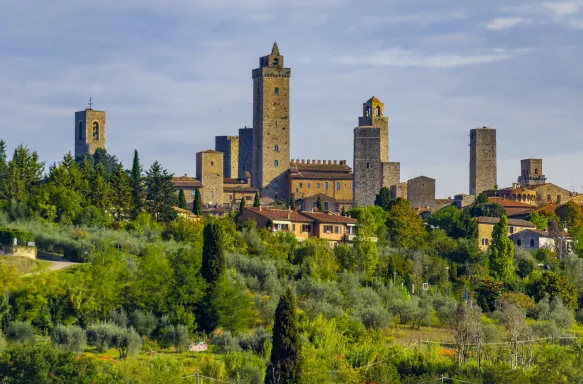 San Gimignano, a small walled medieval hill town with lush vegetation in Siena, Italy