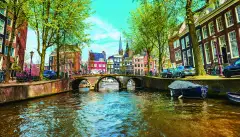 Water canal with traditional houses in Amsterdam