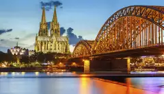 Cologne Cathedral and Hohenzollern bridge illuminated in Cologne, Germany