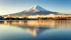 Mount Fuji and its reflection in lake on a bright day in Japan