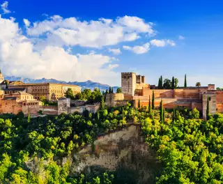 Landscape of Alhambra in Granada in Spain amid a beautiful green hilltop and blue skies