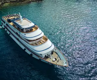 Yacht ship anchored in the crystal blue waters of a croatian bay