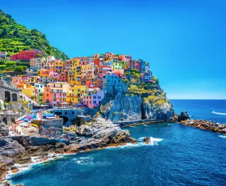 Colourful buildings along the cliffside of Cinque Terre over the Mediterranean sea