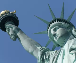 Close-up of the Statue of Liberty against a blue sky in New York