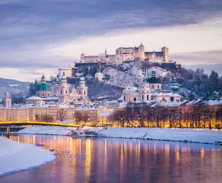 Classic view of Salzburg and Festung Hohensalzburg fortress illuminated at Christmas time in Austria